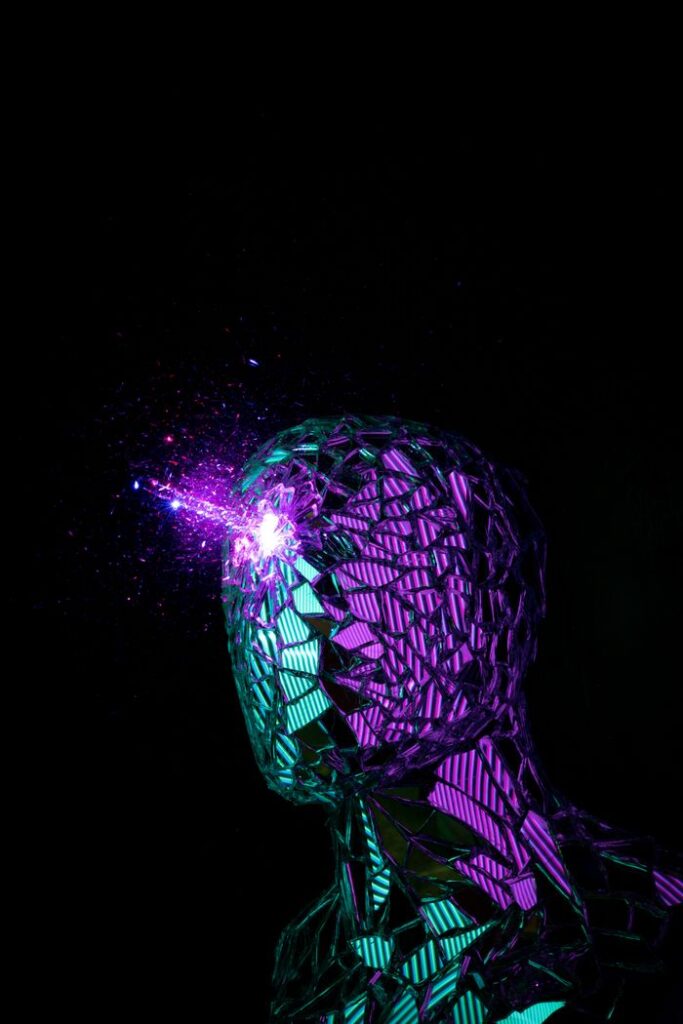 Neon-lit reflective sculpture in abstract style, emitting bright energy.