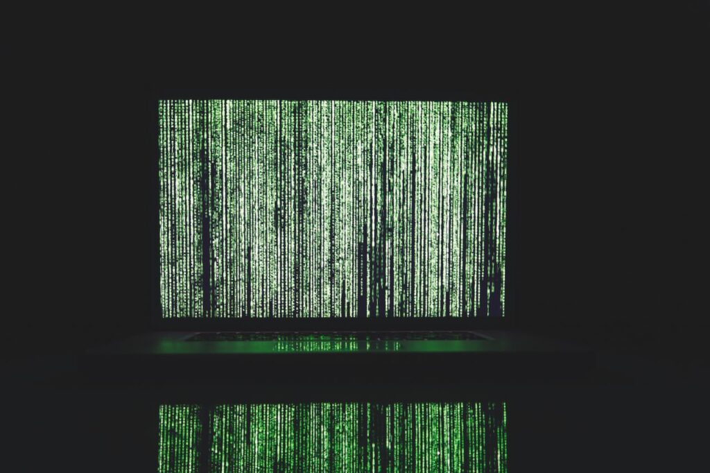 Abstract depiction of green matrix code on a computer monitor.
